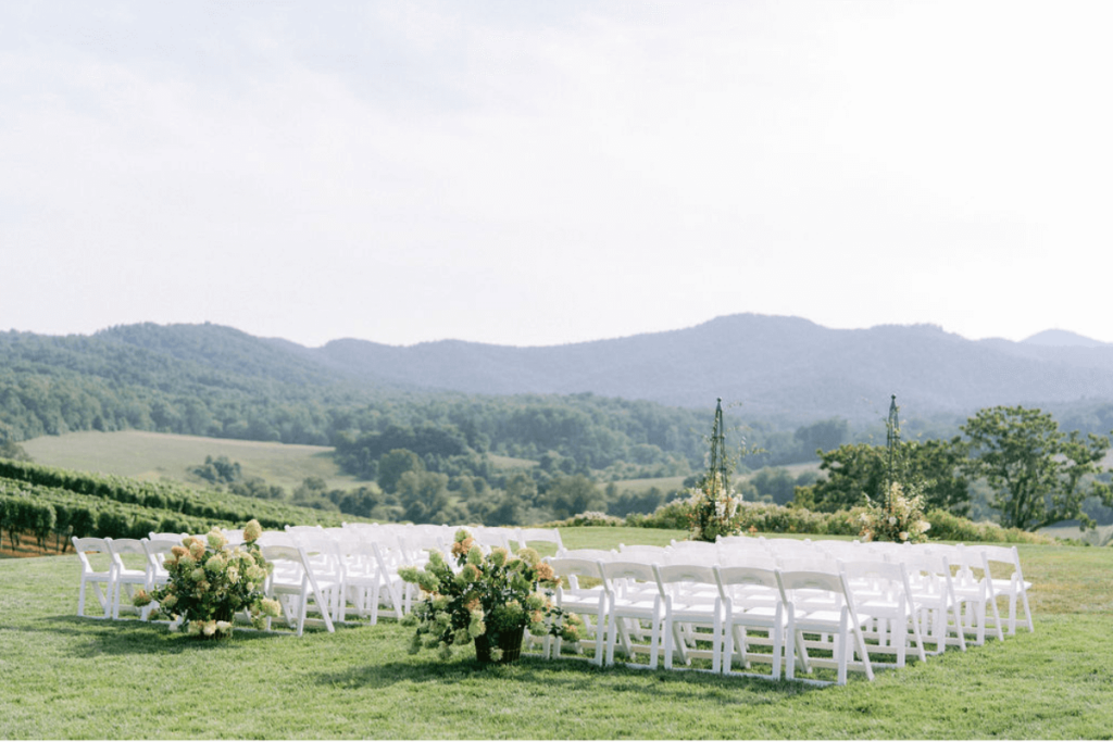Image of white chairs looking out over a vineyard - to capture an environmental image on wedding photographer shot list
