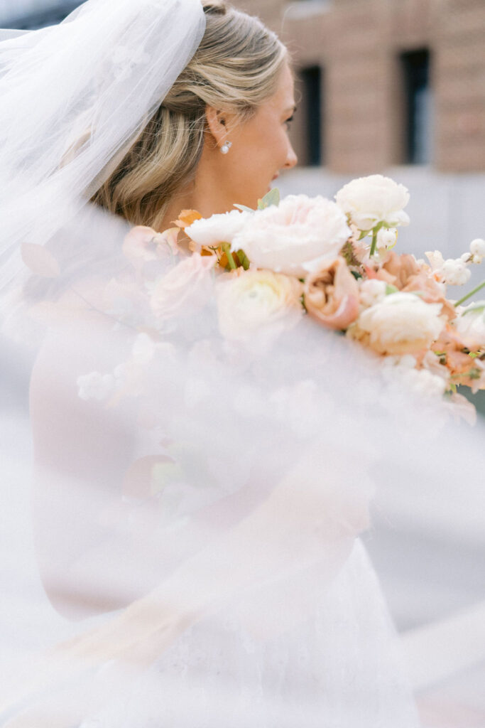 Bride with veil and holding a fall inspired bouquet for her wedding at the Winslow, Baltimore